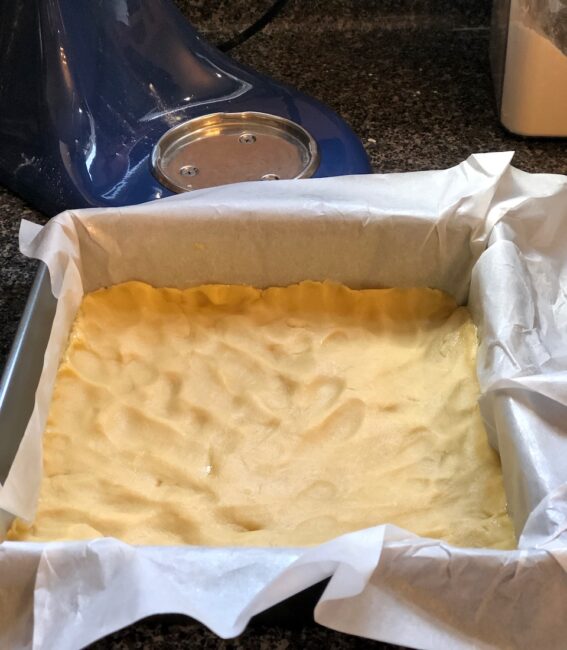 nine inch square baking pan with parchment paper