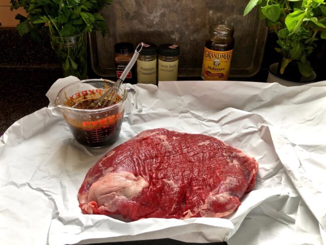 meat marinade ready to be poured on a piece of raw steak