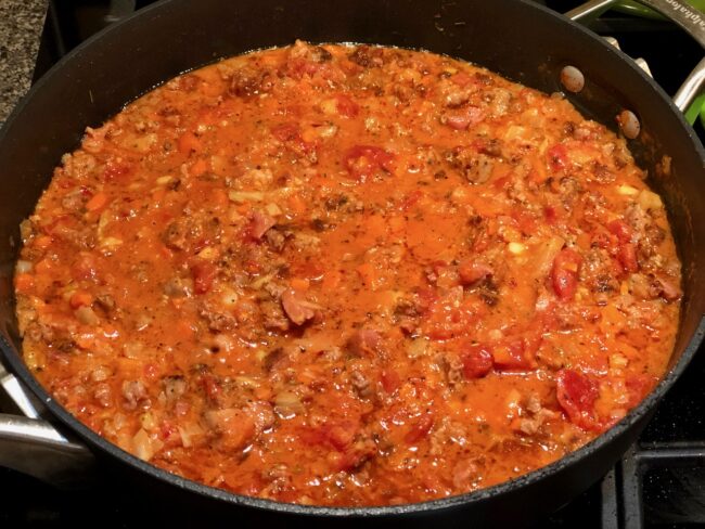 Simmering pasta sauce for Rigatoni with sausage and fennel