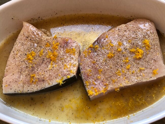 two pieces of swordfish marinating