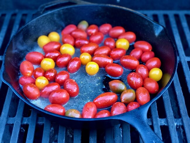 cherry tomatoes marinating in a skillet