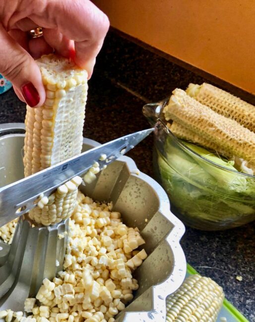 cutting up corn kernels into a bowl